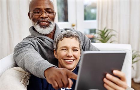 Husband and wife reading from tablet